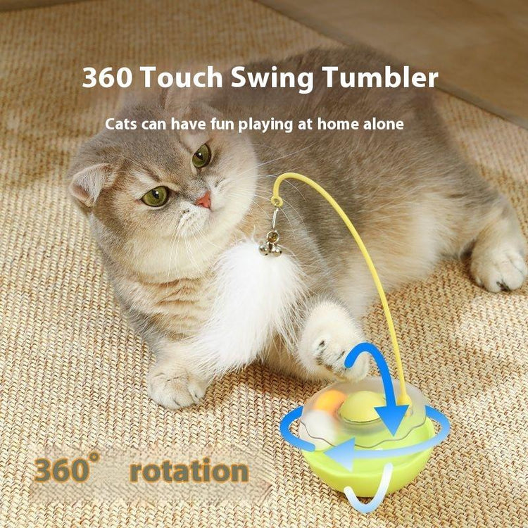 Fluffy cat playing with 360° swing tumbler toy, perfect for solo fun at home