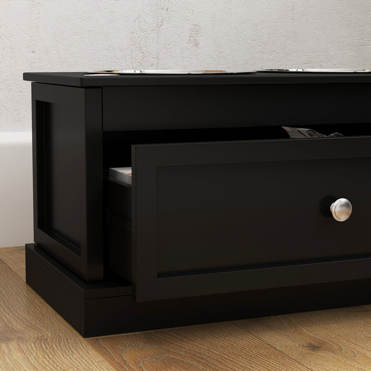Black storage cabinet with open drawer on wooden floor