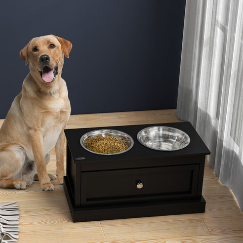 Happy dog beside black elevated pet feeder with food and water bowls, ideal for dog toys and accessories.