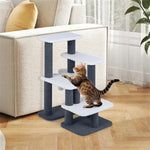 Cat playing on multi-level cat tree with plush platforms and scratching posts, perfect for indoor cat accessories.