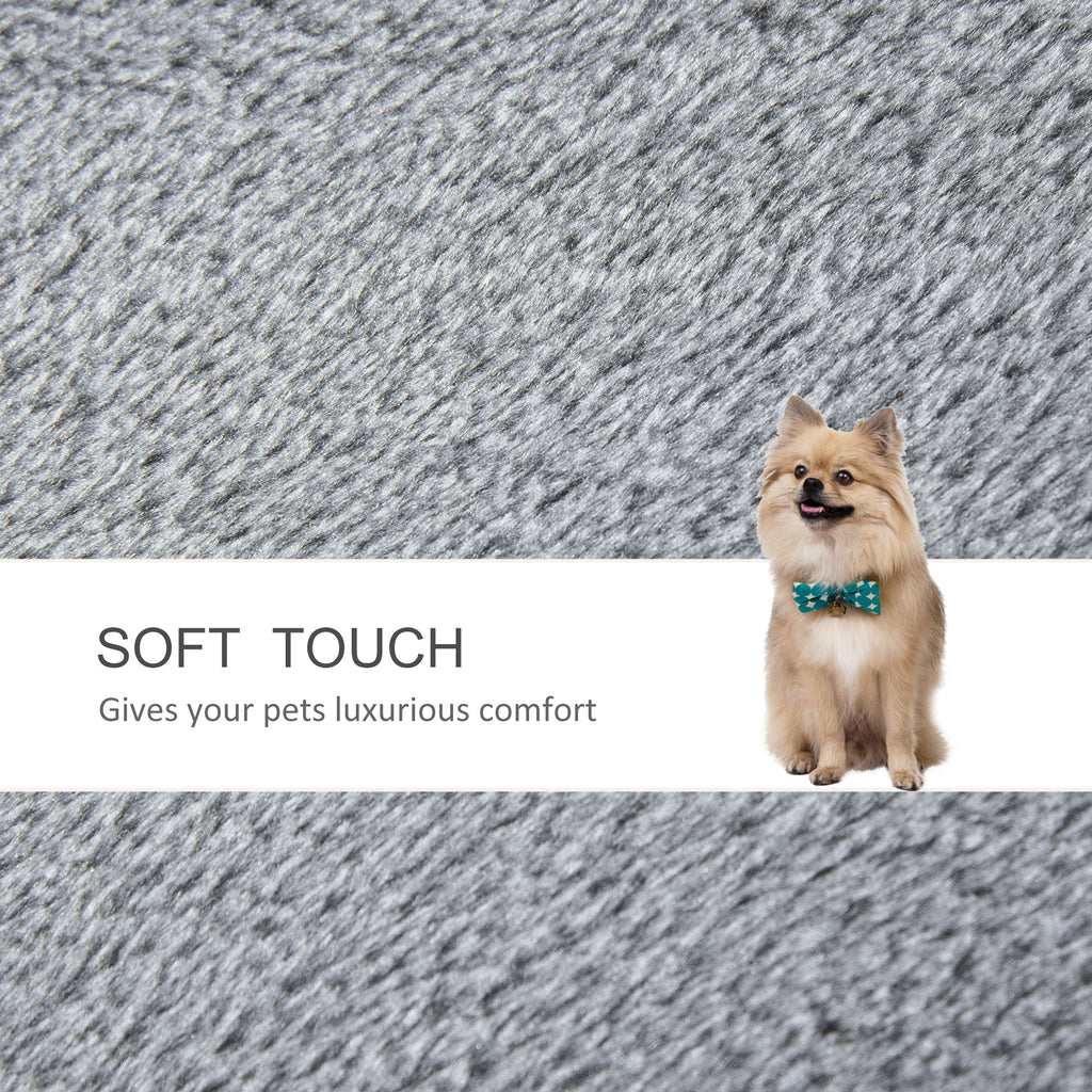 Fluffy Pomeranian dog wearing bow tie on soft gray pet bed, luxurious comfort for pets