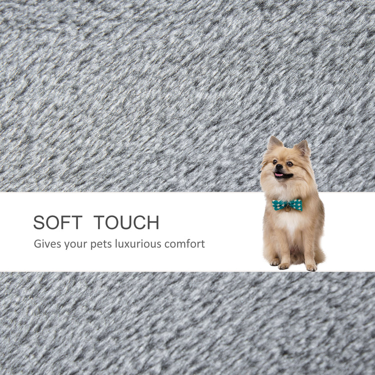 Fluffy Pomeranian dog wearing bow tie on soft gray pet bed, luxurious comfort for pets